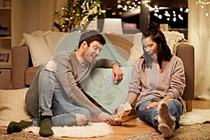 Happy couple playing block-stacking game at home