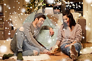 Happy couple playing block-stacking game at home