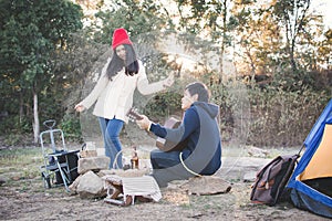 Happy couple playing guitar in nature winter season