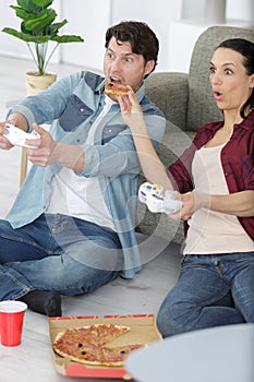 happy couple playing video games at home