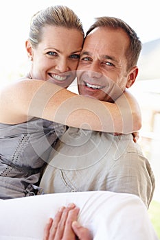 Happy couple, portrait and carry with love, excited and bonding at home or holiday and vacation for honeymoon. Man and