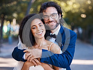 Happy, couple portrait and outdoor for wedding celebration event with a hug for commitment. Interracial man and woman at