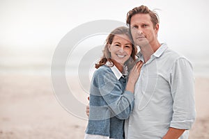 Happy, couple and portrait smile on a beach together relaxing while enjoying quality bonding time in the outdoors. Man