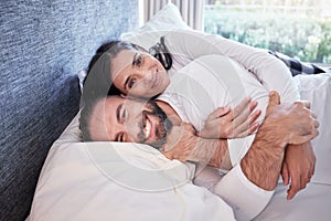 Happy, couple and portrait together in bed, home or waking up on the weekend, morning or sleeping in on a holiday. Relax