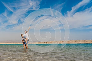 Happy couple posing at lake in desert of Ras Mohammed National Park