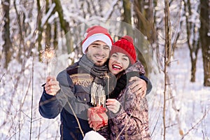 Happy couple posing with red hats, bengals at winter park