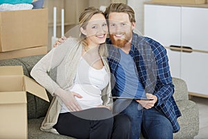 happy couple pregnant moving out photo