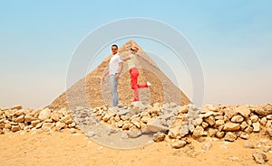 Happy couple and Pyramid, Cairo, Egypt. Tourists having fun