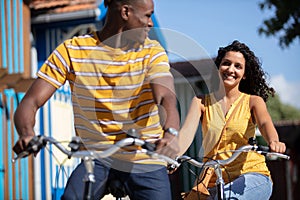 happy couple racing on bikes