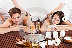 Happy Couple Receiving Shoulder Massage At Beauty Spa