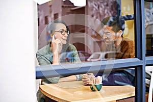 Happy couple, relax and enjoying cafe with date for conversation, bonding or romance at indoor restaurant. Man and woman