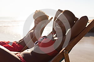 Happy couple relaxing in a beach chair on the beach