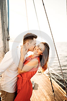 Happy couple relaxing on a boat at sea. Luxury holiday on a yacht