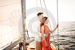 Happy couple relaxing on a boat at sea. Luxury holiday on a yacht