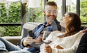 Happy couple relaxing with a glass of wine