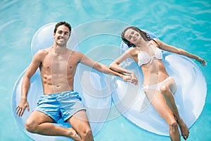 Happy couple relaxing on inflatable ring