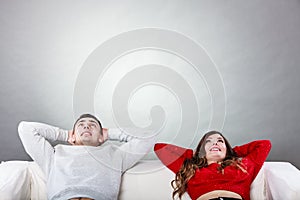 Happy couple relaxing resting on couch at home.