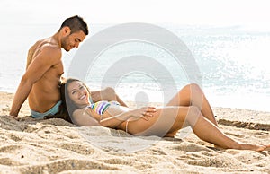 Happy couple relaxing on sand beach