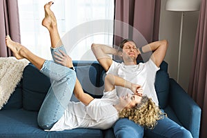 Happy couple relaxing on the sofa at home