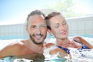 Happy couple relaxing in spa hot tub