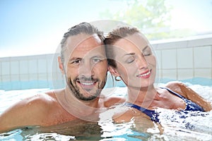 Happy couple relaxing in spa hot tub photo