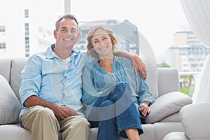 Happy couple relaxing on their couch