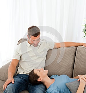 Happy couple relaxing together on the sofa