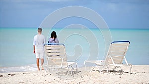 Happy couple relaxing on a tropical beach. Family of two walking together on caribbean holidays