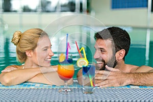 Happy couple relaxing at wellness spa center