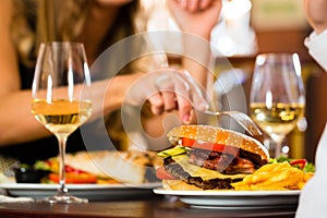 Happy couple in restaurant eat fast food