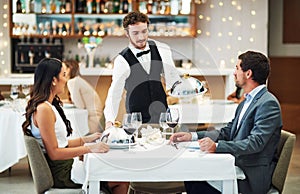 Happy couple, restaurant server and fine dining food for valentines day date, love or romance in night. Man, woman and