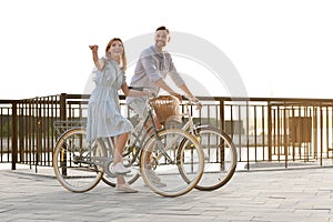 Happy couple riding bicycles outdoors