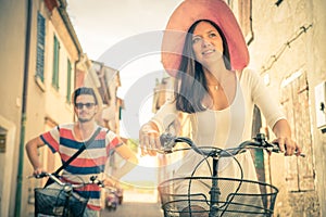 Happy couple riding bicycles outdoors