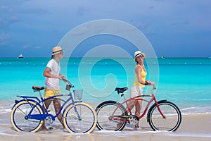 Happy couple riding bikes during tropical vacation