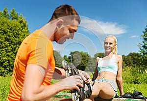 Happy couple with rollerblades outdoors