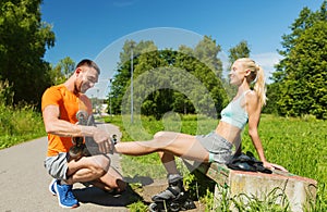 Happy couple with rollerblades outdoors