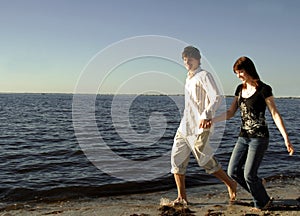 Happy couple running on beach