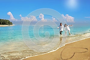 Happy couple running at beach