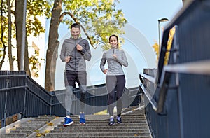 Happy couple running downstairs in city