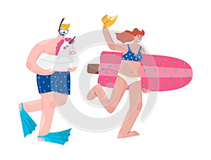 Happy couple running to the sea with inflatable toys and diving mask.