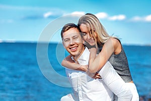 Happy couple on sea background. happy young romantic couple in love have fun on l beach at beautiful summer day