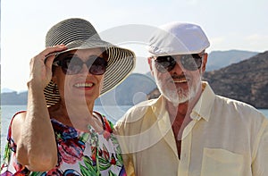 Happy couple of seniors on the tourist boat  smiling, enjoying trip on the Mediterranian sea photo