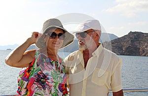 Happy couple of seniors on the tourist boat  smiling, enjoying trip on the Mediterranian sea