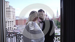 Happy couple sharing joyful moment in formal wear at wedding event.