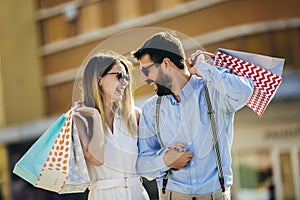 Happy couple with shopping bags.People,sale,consumerism and lifestyle concept