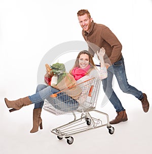 Happy couple with shopping cart