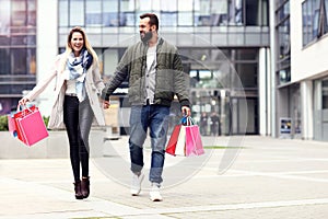 Happy couple shopping in the city