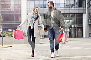 Happy couple shopping in the city