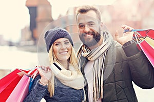 Happy couple shopping in the city