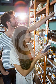 Happy couple shopping for groceries